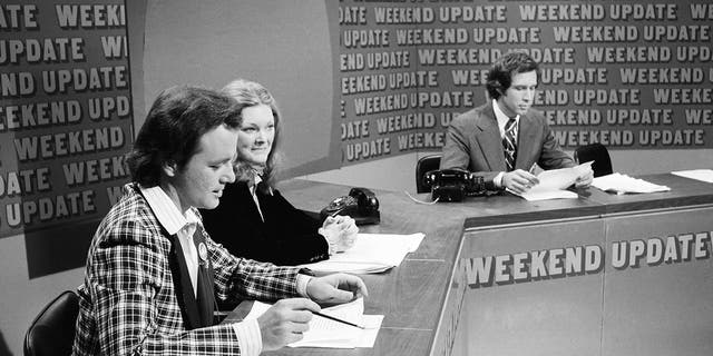 SATURDAY NIGHT LIVE -- Episode 11 -- Pictured: (l-r) Bill Murray, Jane Curtin, Chevy Chase during 'Weekend Update' on February 18, 1978. 