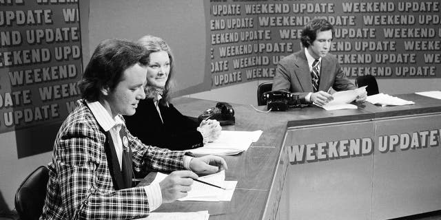 SATURDAY NIGHT LIVE -- Episode 11 -- Pictured: (l-r) Bill Murray, Jane Curtin, Chevy Chase during 'Weekend Update' on February 18, 1978.