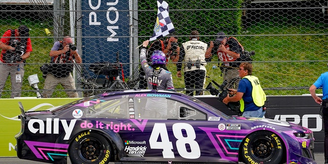 Alex Bowman waves the checkered flag after his victory at Pocono Raceway.