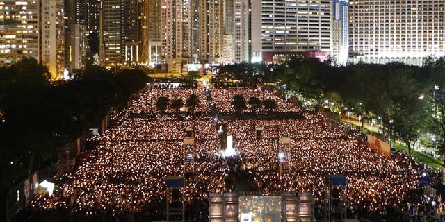 Thousands of people attend a candlelight vigil in Hong Kong's Victoria Park to mark the anniversary of the military crackdown on a pro-democracy student movement in Beijing. 
