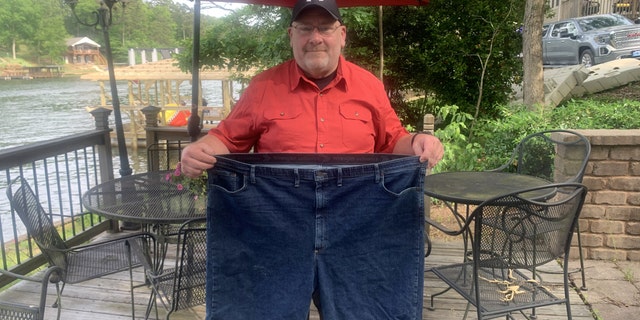 Before he started gaining weight, Moore (pictured) was a personal trainer. However, after becoming a single dad and after both his parents died, Moore spent years gaining weight, eventually reaching 443 pounds.