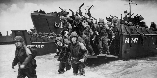 D-Day forces enter the water from docked war ships