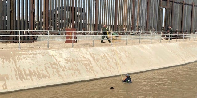 Migrants are seen being rescued by Border Patrol agents from a canal along U.S.-Mexico border near El Paso.