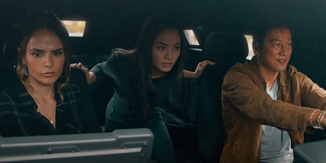 This image released by Universal Pictures shows Jordana Brewster, from left, Anna Sawai and Sung Kang in a scene from "F9: The Fast Saga."