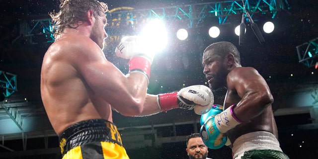 Logan Paul, left, and Floyd Mayweather fight during an exhibition boxing match at Hard Rock Stadium, Sunday, June 6, 2021, in Miami Gardens, Fla. (AP Photo/Lynne Sladky)