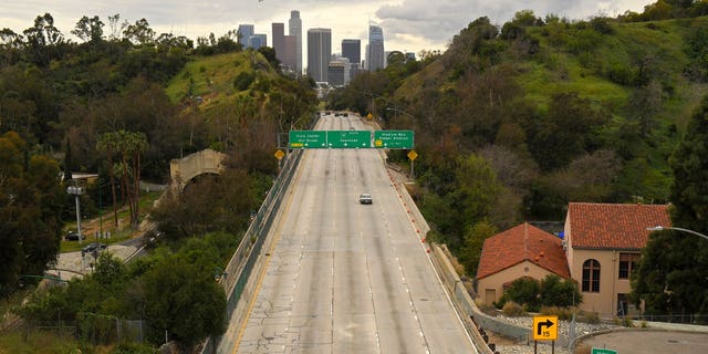 Extremely light traffic moves along the 110 Harbor Freeway toward downtown Los Angeles in mid-afternoon, March 20, 2020. (Associated Press)