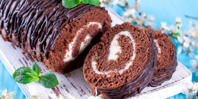 A Swiss roll is typically made from a cream- or jelly-covered sheet cake that's been rolled into the shape of a log. The two layers create a swirling design within the dessert's interior. (iStock)