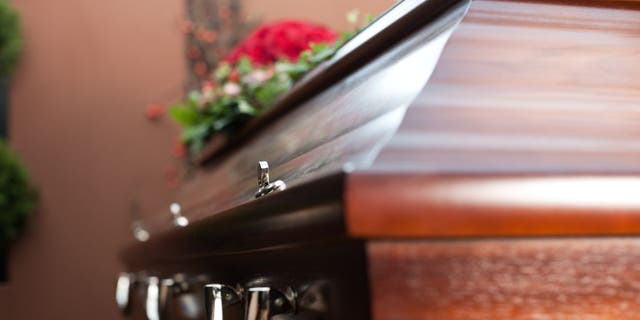 FILE- A casket at a funeral.