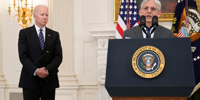 President Joe Biden, left, listens as Attorney General Merrick Garland, right, speaks during an event in the State Dining room of the White House in Washington, Wednesday, June 23, 2021, to discuss gun crime prevention strategy. (AP Photo/Susan Walsh)