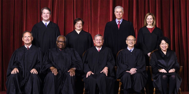 Seated from left are Justices Samuel Alito and Clarence Thomas, Chief Justice John Roberts, and Justices Stephen Breyer and Sonia Sotomayor, Standing from left are Justices Brett Kavanaugh, Elena Kagan, Neil Gorsuch and Amy Coney Barrett.