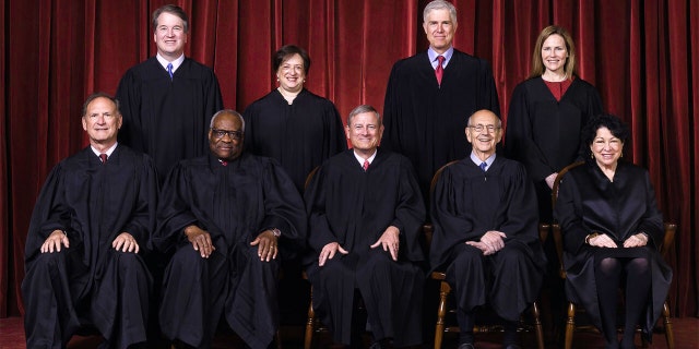 Members of the Supreme Court pose on April 23, 2021. They are, seated from left Justices Samuel Alito and Clarence Thomas, Chief Justice John Roberts, Justices Stephen Breyer and Sonia Sotomayor, and, standing from left, Justices Brett Kavanaugh, Elena Kagan, Neil Gorsuch and Amy Coney Barrett.