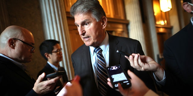 Sen. Joe Manchin talks with reporters after stepping off the Senate floor at the U.S. Capitol on May 28, 2021.