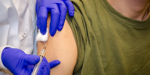 A vaccine being administered. 