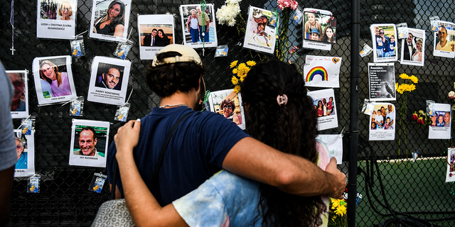 People visit a makeshift memorial for victims of the building collapse near the site of the accident in Surfside, Fla., June 27, 2021