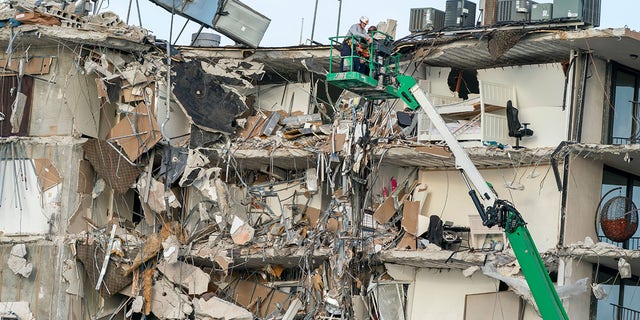 Rescue workers survey a wing of a partially collapsed 12-story beachfront condo building, June 25, 2021, in Surfside, Fla.Xxx 062521 Building Collapse 01 Jpg Usa Fl