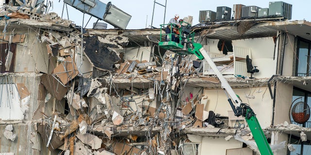 Rescue workers survey a wing of a partially collapsed 12-story beachfront condo building, June 25, 2021, in Surfside, Fla.Xxx 062521 Building Collapse 01 Jpg Usa Fl