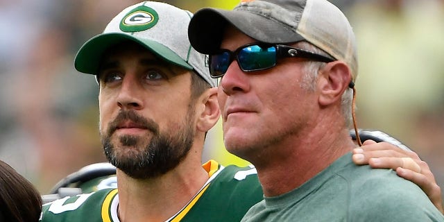 Aaron Rodgers #12 of the Green Bay Packers shares a moment with former quarterback Brett Favre during a ceremony for the late Bart Starr at halftime of the game between the Minnesota Vikings and Green Bay Packers at Lambeau Field on September 15, 2019 in Green Bay, Wisconsin.