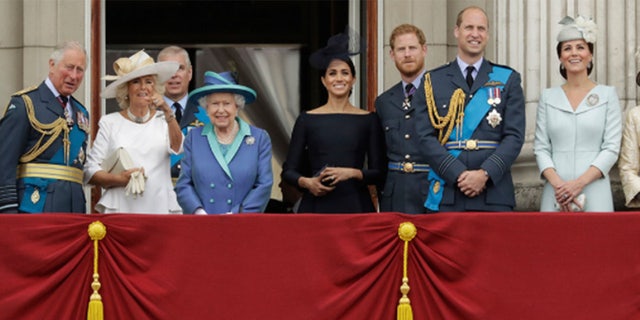 Members of the royal family gather on the balcony of Buckingham Palace, with from left, Prince Charles, Camilla the Duchess of Cornwall, Prince Andrew, Queen Elizabeth II, Meghan the Duchess of Sussex, Prince Harry, Prince William and Kate the Duchess of Cambridge, as they watch a flypast of Royal Air Force aircraft pass over Buckingham Palace.