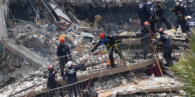 Search and rescue teams are looking for possible survivors in the partially collapsed 12-story Champlain Towers South apartment building on Sunday. 