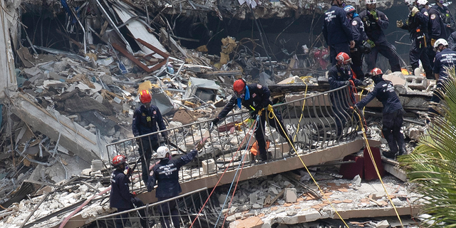 Search and rescue teams are looking for possible survivors in the partially collapsed 12-story Champlain Towers South apartment building on Sunday.