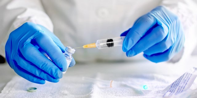 File photo of a medical worker handling a syringe.
