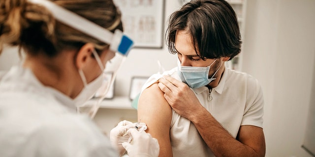 File photo of a man receiving a shot in a doctor's office.