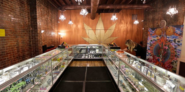 Dec. 7, 2015: In this photo, a worker cleans a display case at the Ganja Goddess Cannabis Store in Seattle.