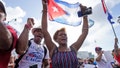 Dulce Diaz, center, and her brother Carlos Diaz, left, demonstrate, Wednesday, July 14, 2021, in Miami's Little Havana neighborhood, as people rallied in support of antigovernment demonstrations in Cuba