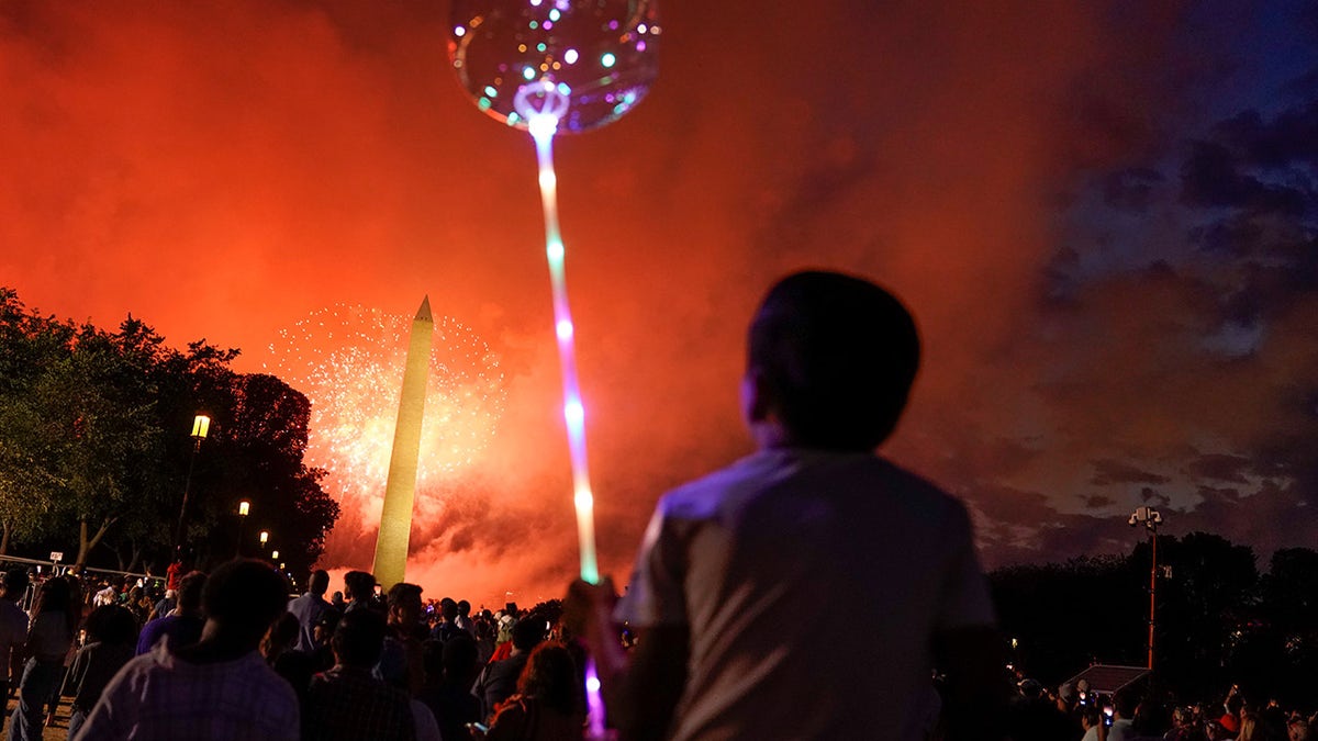 People enjoy the fireworks as they gather for the annual Independence Day celebration at the National Mall in Washington, U.S., July 4, 2021. (REUTERS)