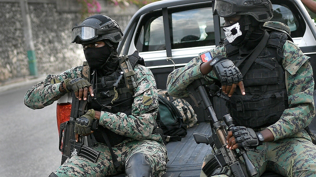 Soldiers stand guard near the residence of Interim President Claude Joseph in Port-au-Prince, Haiti, Sunday, July 11, 2021, four days after the assassination of Haitian President Jovenel Moise. (AP Photo/Matias Delacroix)