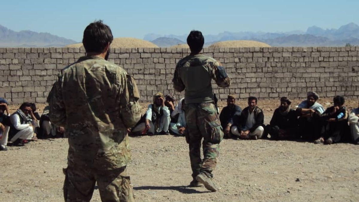 Moneer and Greg Adams speaking to village elders and recruits from throughout the Afghan district.