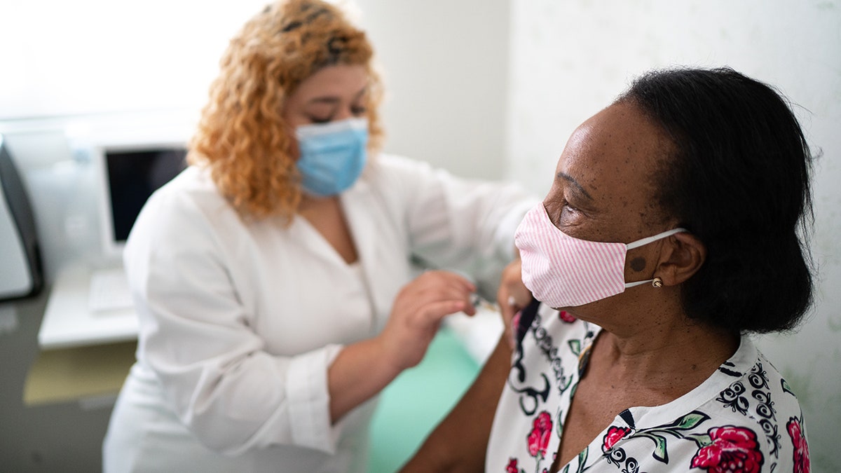 nurse gives vaccine