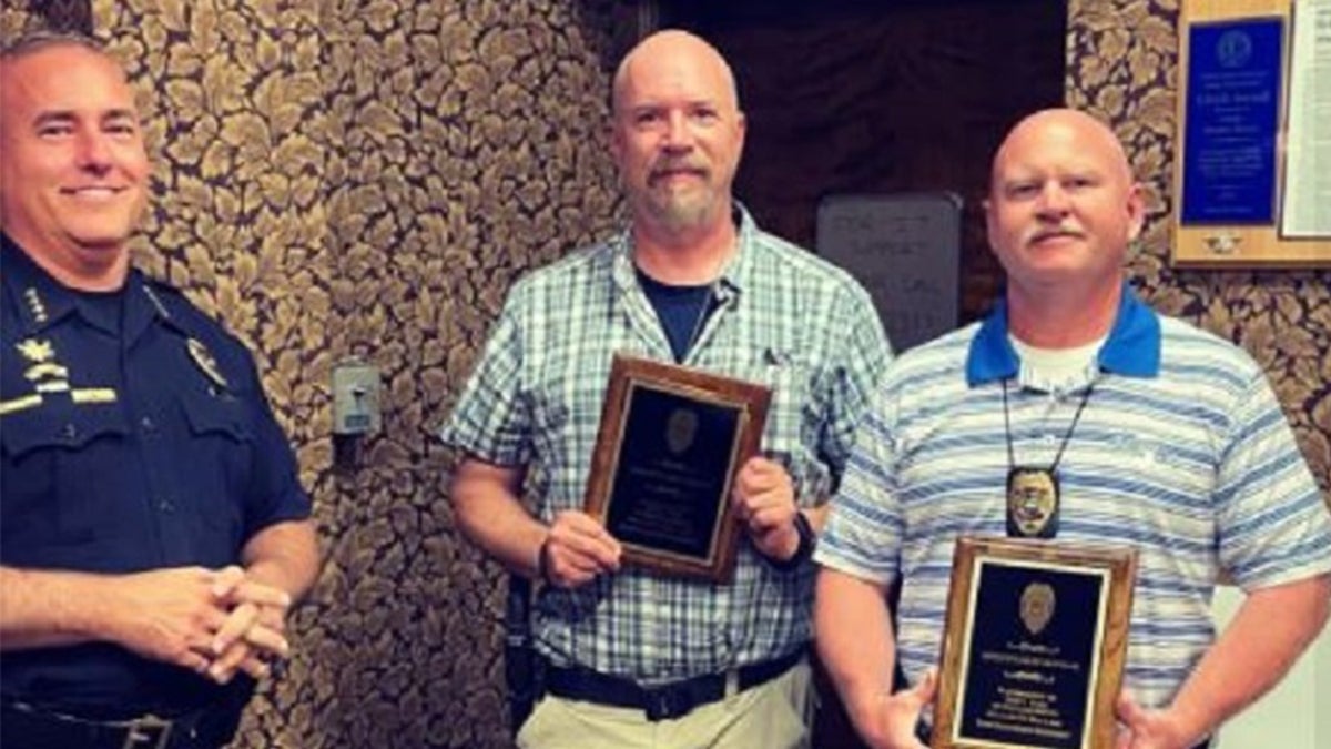 Detective Greg Ferency, middle, receives an award for completeing 30 years with the Terre Haute Police Department. He was killed Wednesday outside a federal building while on assignment with an FBI taskforce, officials said. 