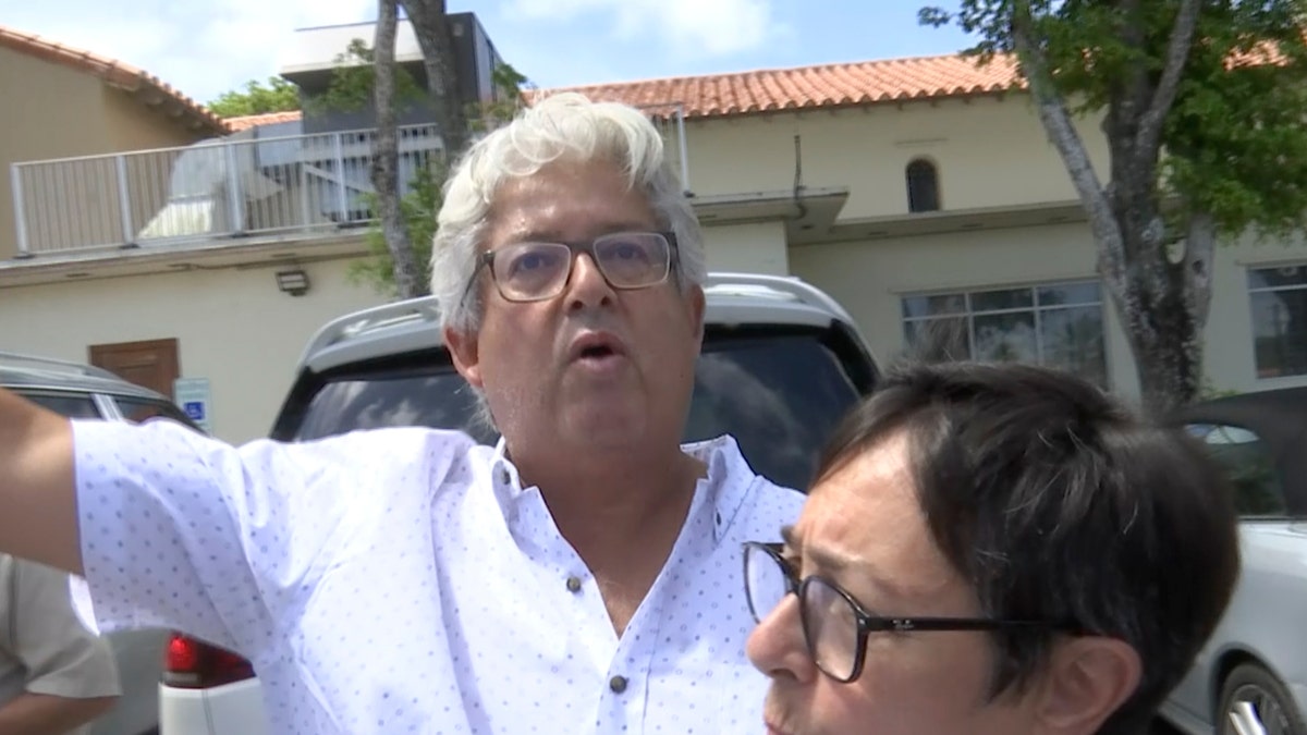 In this Sunday, June 27, 2021 image from video, Alfredo Lopez talks about how his family escaped from the Champlain Towers South condo building in Surfside, Fla. Lopez and his wife, Marian, right, were asleep when the first thundering blast jolted them awake. Alfredo rushed to wake his 24-year-old son, Michael. When Alfredo opened the front door that night, half of the building was gone. A jagged five-foot chunk of flooring barely left enough room to escape. "There was no hallway, no ceiling, no apartments, no walls, nothing." The 61-year-old froze in terror, unable to move. "I was petrified. I really thought, ‘This is it. We are going to die’." (AP Photo/Stacey Plaisance)