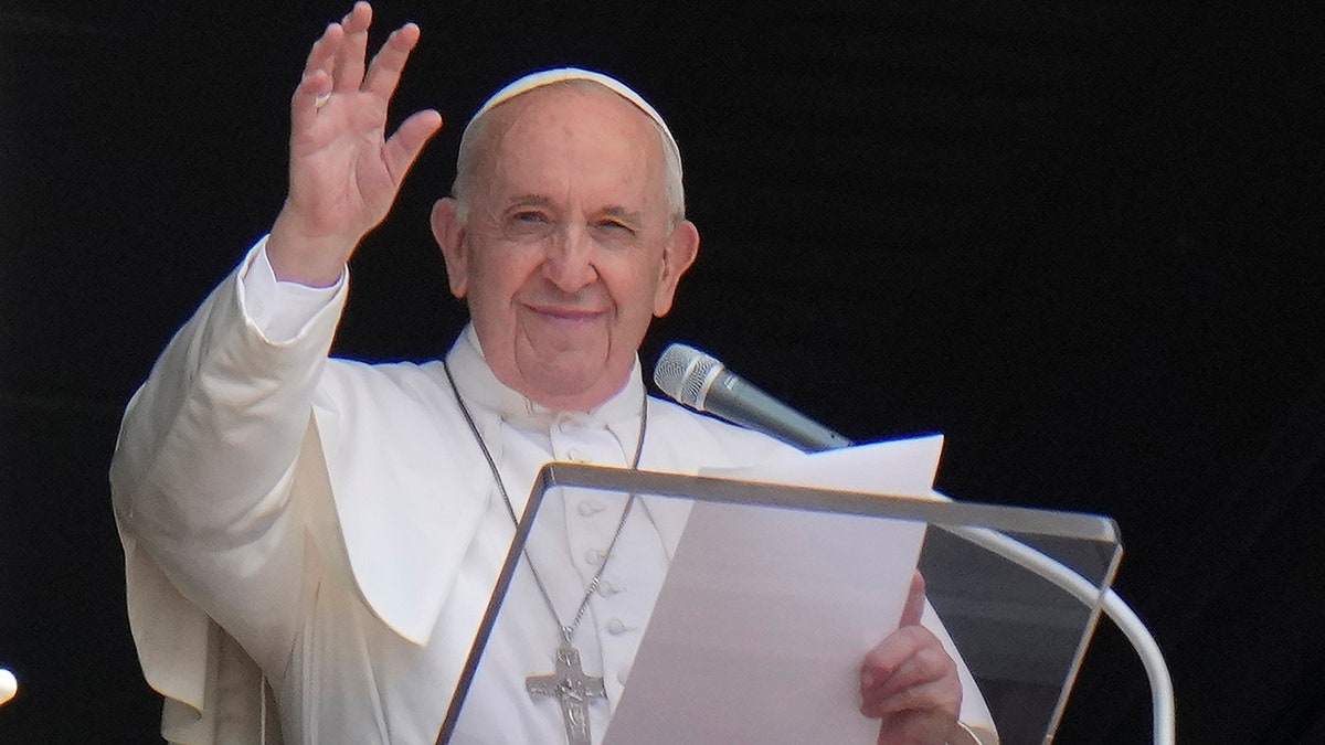 Pope Francis waves to the crowd as he arrives to recite the Angelus noon prayer from the window of his studio overlooking St. Peter's Square, at the Vatican on July 4, 2021. (Associated Press)