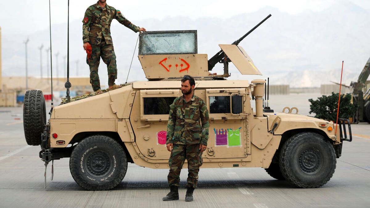 Afghan army soldiers stand guard after the American military left Bagram air base, in Parwan province north of Kabul, Afghanistan, Monday, July 5, 2021. 