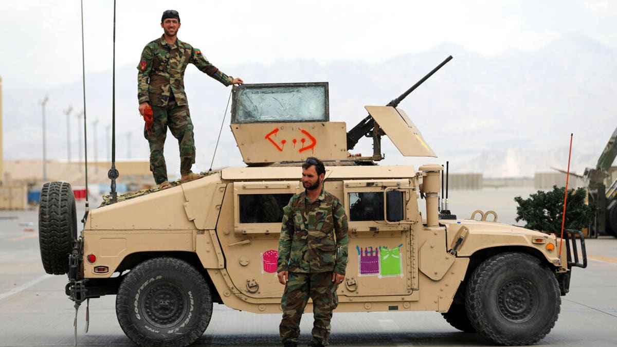 Afghan army soldiers stand guard after the American military left Bagram air base, in Parwan province north of Kabul, Afghanistan, Monday, July 5, 2021.