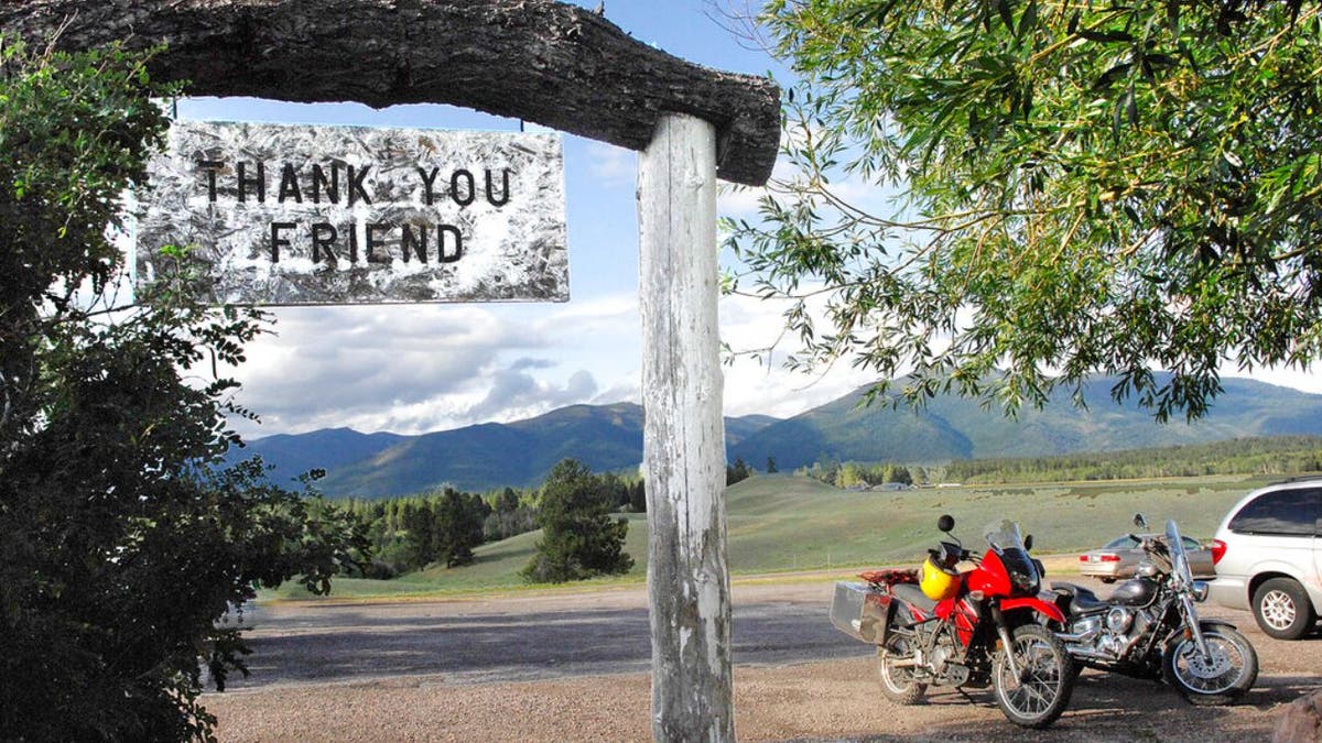 In this July 9, 2009, file photo, the Bob Marshall Wilderness cuts a jagged line across the horizon as patrons leave Trixi's Antler Saloon in Ovando, Mont.