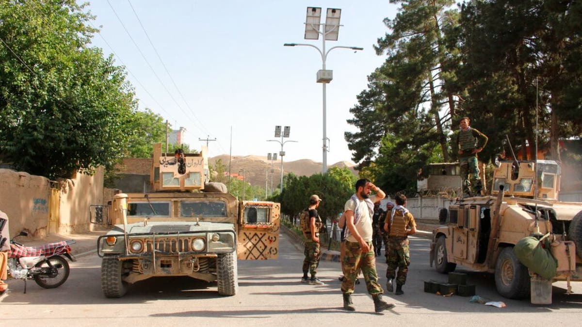 Afghan soldiers pause on a road at the front line of fighting between Taliban and Security forces, in Badghis province, northwest of Afghanistan, Wednesday, July, 7 2021. 