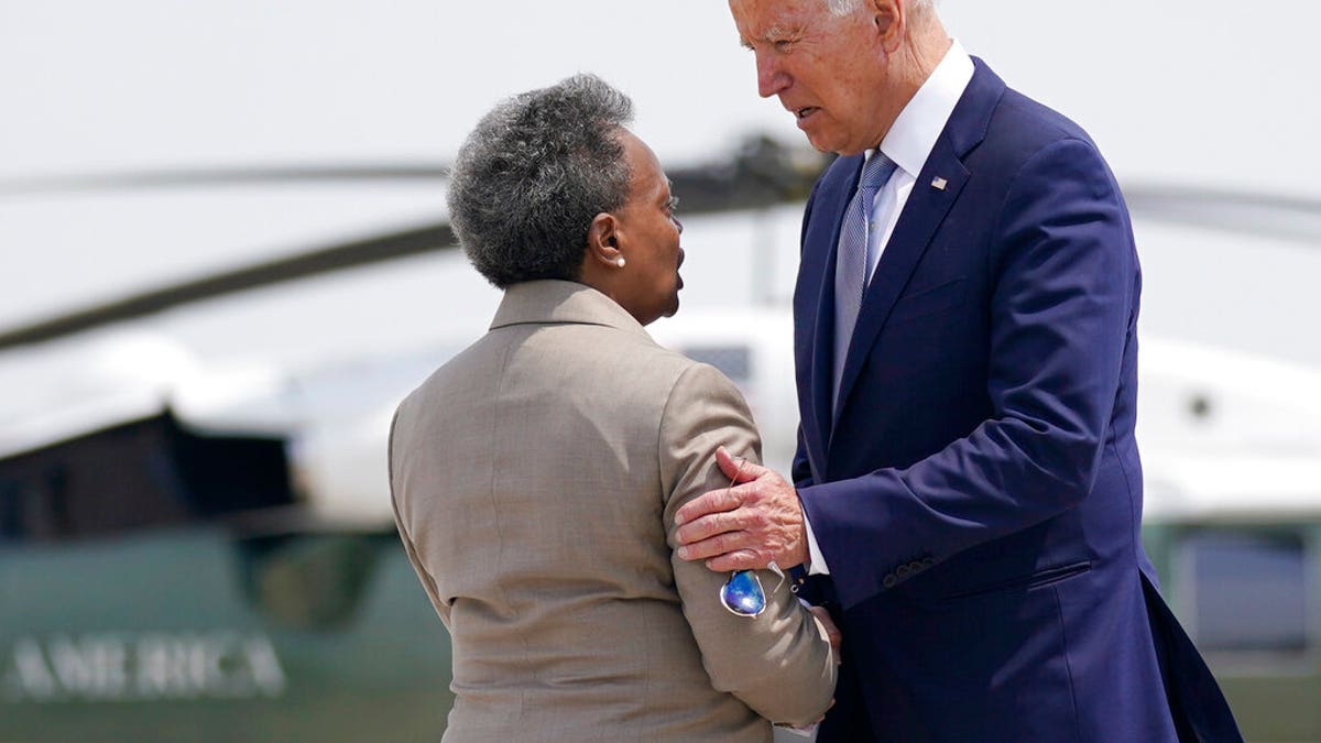 President Joe Biden greets Chicago Mayor Lori Lightfoot, as he arrives at O'Hare International Airport, Wednesday, July 7, 2021, in Chicago. (AP Photo/Evan Vucci)