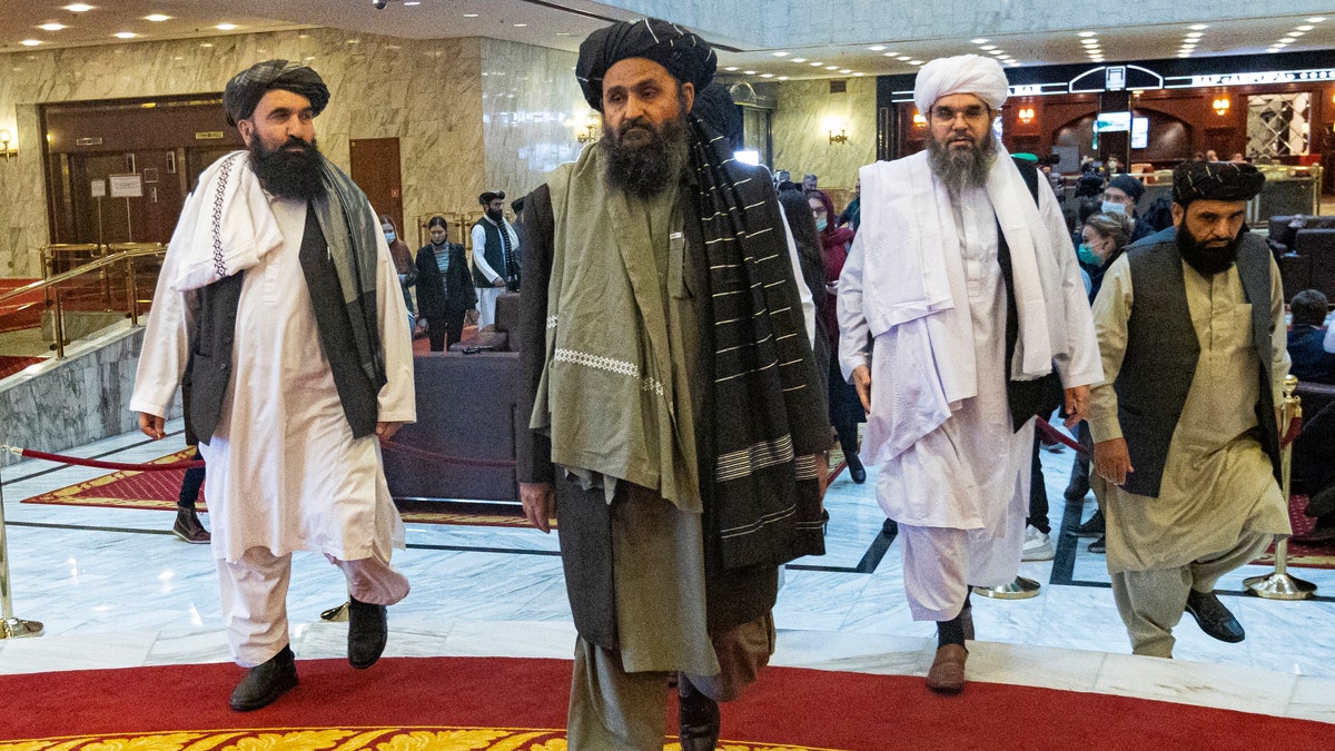 FILE  - In this file photo taken on Thursday, March 18, 2021, Taliban co-founder Mullah Abdul Ghani Baradar, center, arrives with other members of the Taliban delegation for an international peace conference in Moscow, Russia. A delegation of the Taliban visited Moscow on Thursday, July 8, 2021 to offer assurances that their quick gains in Afghanistan don't threaten Russia or its allies in Central Asia. (AP Photo/Alexander Zemlianichenko, Pool, File)