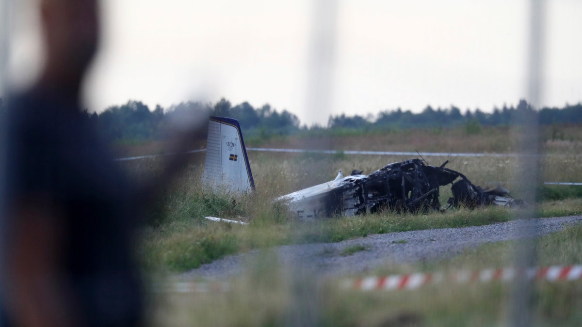 Emergency services at the scene of small aircraft crash, at Orebro Airport in Sweden, Thursday, July 8 2021. The airplane was used by the local parachute club with nine people on board. According to the police, multiple fatalites were reported. (Jeppe Gustafsson/TT News Agency via AP)