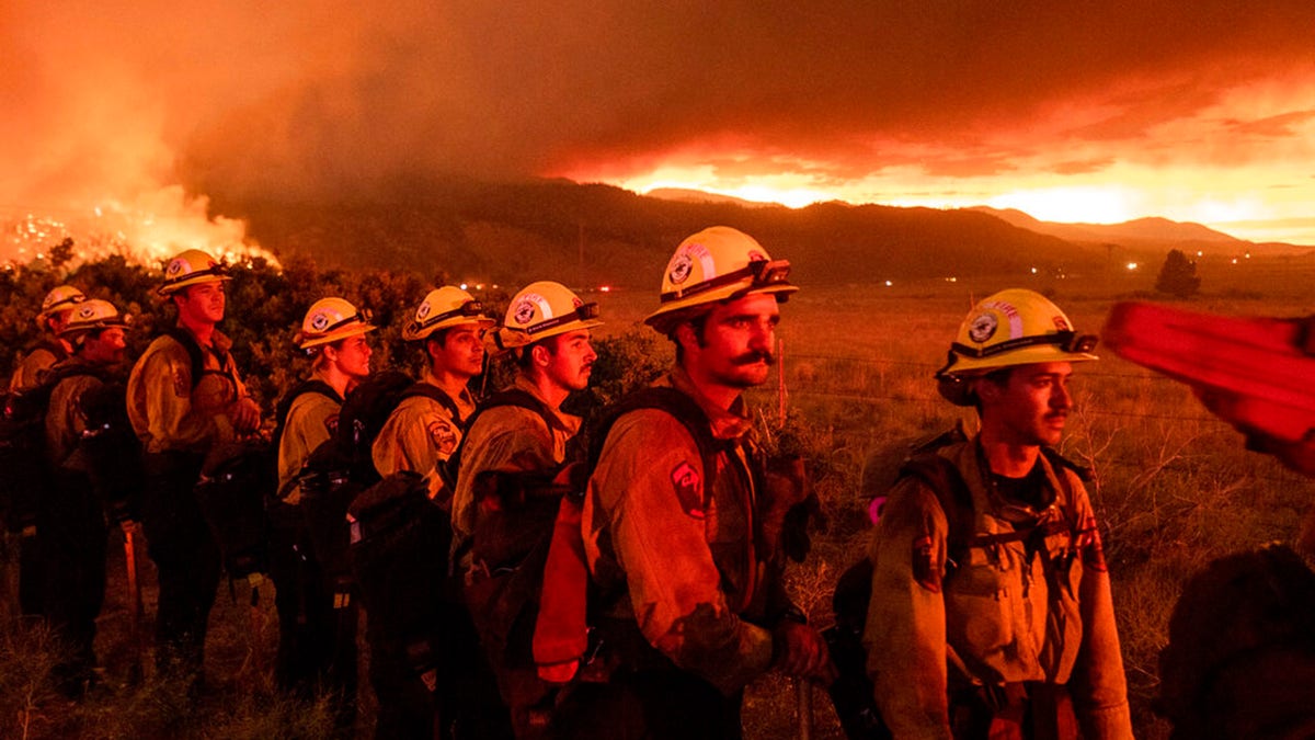 Firefighters from Cal Fire's Placerville station monitor the Sugar Fire, part of the Beckwourth Complex Fire, in Doyle, Calif., on Friday, July 9, 2021. (AP Photo/Noah Berger)