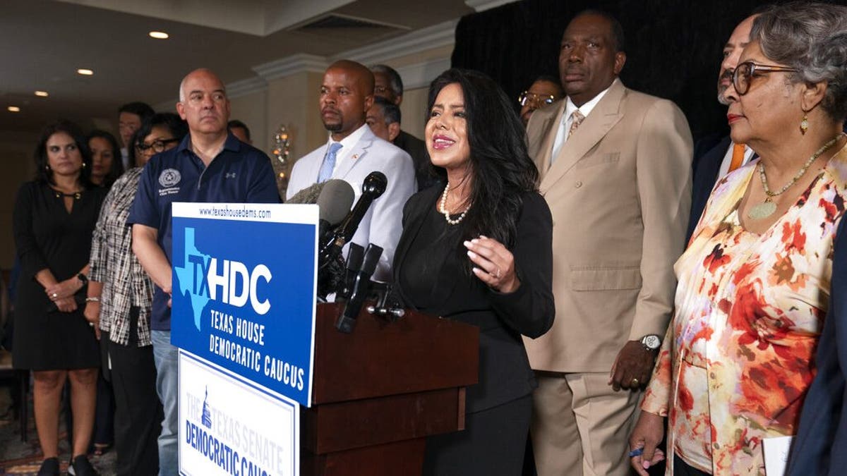 Democratic Texas State Rep. Victoria Neave from Dallas, center, together with fellow Texas legislators, speaks during a news conference, Wednesday, July 14, 2021, in Washington. (AP Photo/Manuel Balce Ceneta)