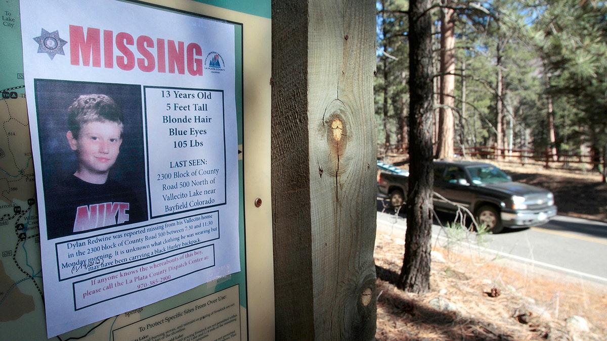 A missing poster of 13-year-old Dylan Redwine hangs on a trail head sign next to Vallecito Reservoir in Vallecito, Colorado, Nov. 26, 2012.
