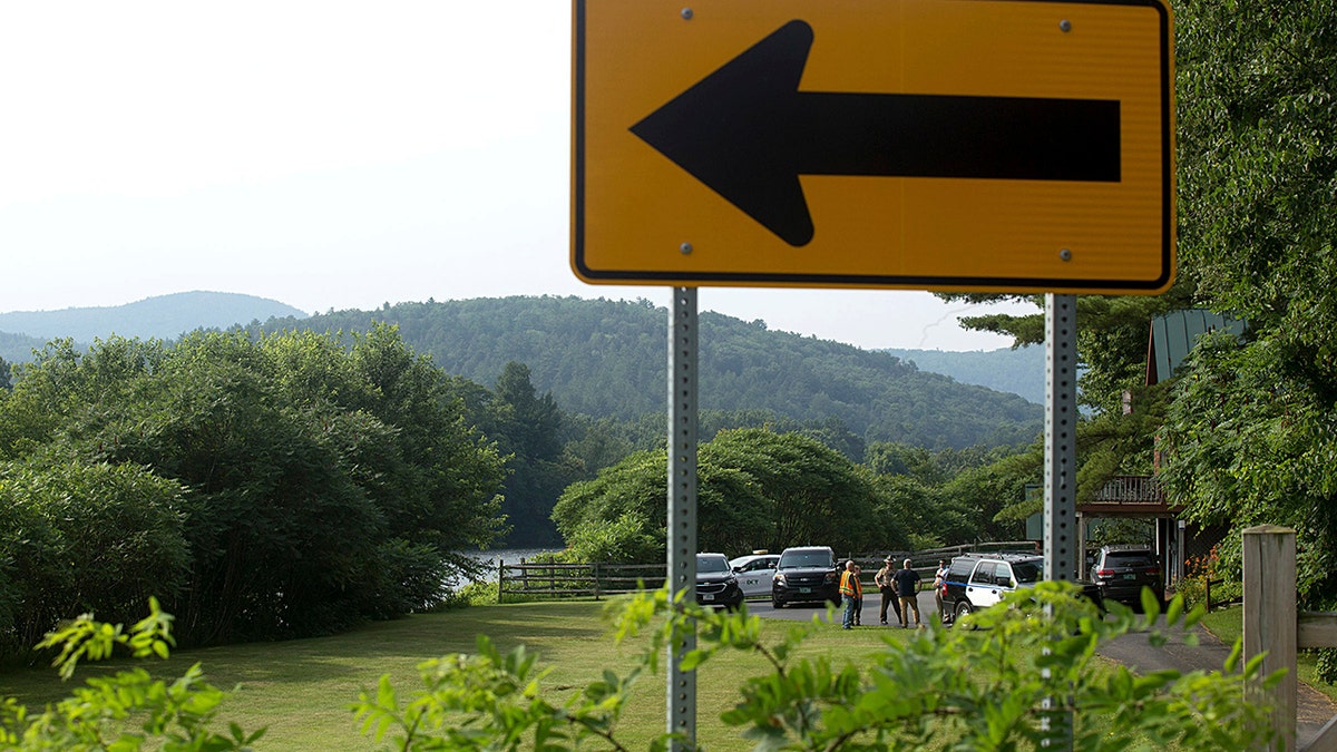 Investigators, including those from the Federal Aviation Administration, gather along the Connecticut River and Route 25 in Bradford, Vt., on Friday, July 16, 2021, following the death of a hot-air balloonist. (Associated Press)
