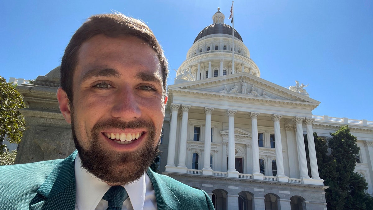 In a photo provided by Kevin Paffrath, Kevin Paffrath smiles for a selfie in front of the California State Capitol in Sacramento on Friday, July 16, 2021. The 29-year-old YouTuber is one of the Democrats running in the recall against California Gov. Gavin Newsom. (Kevin Paffrath via AP)