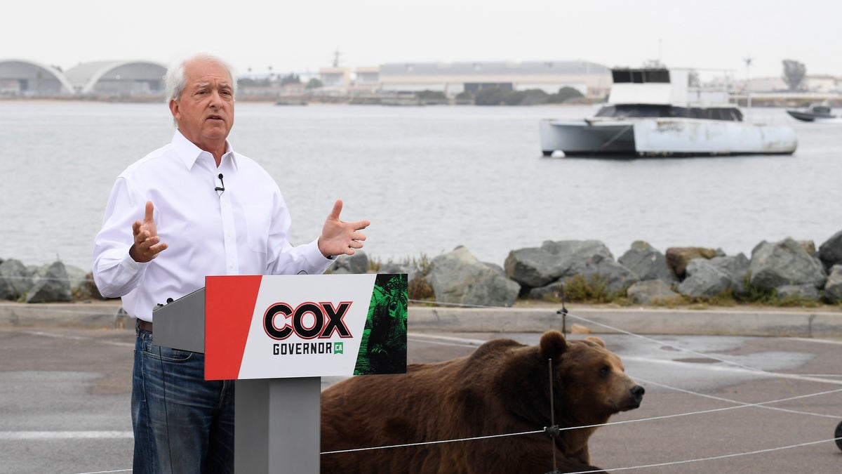 In this May 11, 2021, file photo California gubernatorial candidate John Cox speaks in front of his Kodiak bear at a campaign event held on Shelter Island in San Diego. Cox was the Republican nominee for governor in 2018 and lost to Newsom in a landslide. This time around the multimillionaire businessman has displayed a showman’s instincts. (AP Photo/Denis Poroy, File)