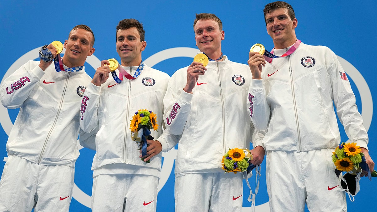United States men's 4x100m freestyle relay team of Caeleb Dressel, Blake Pieroni, Bowen Beck and Zach Apple, celebrate with their medals after winning the gold medal at the 2020 Summer Olympics