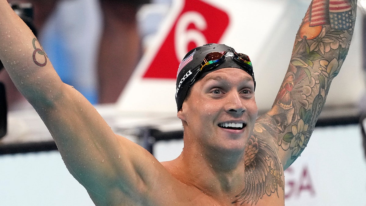 Caeleb Dressel of the United States celebrates winning the men's 100-meter freestyle final at the 2020 Summer Olympics, Thursday, July 29, 2021, in Tokyo, Japan. (AP Photo/Matthias Schrader)